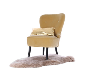 Photo of Comfortable armchair with cushion and faux fur rug isolated on white