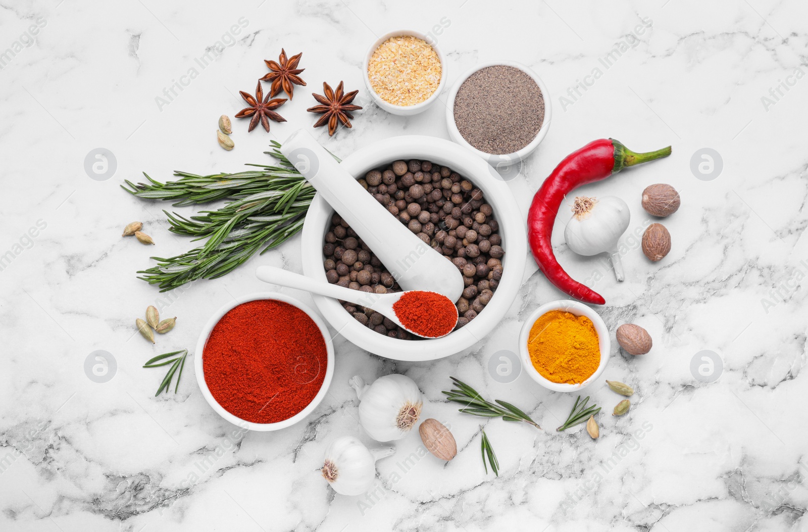 Photo of Flat lay composition with mortar and different spices on white marble table