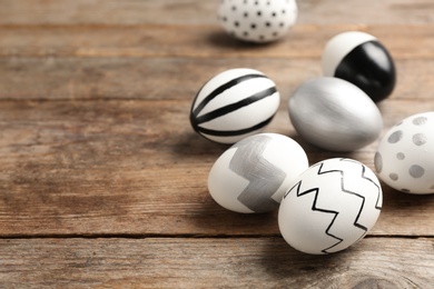 Painted Easter eggs on wooden background. Space for text