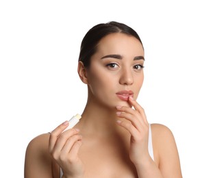 Photo of Young woman with lip balm on white background