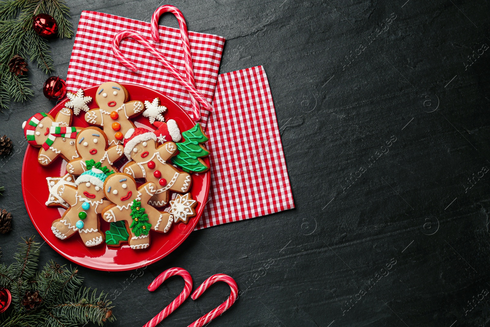 Photo of Flat lay composition with delicious Christmas cookies on black table, space for text