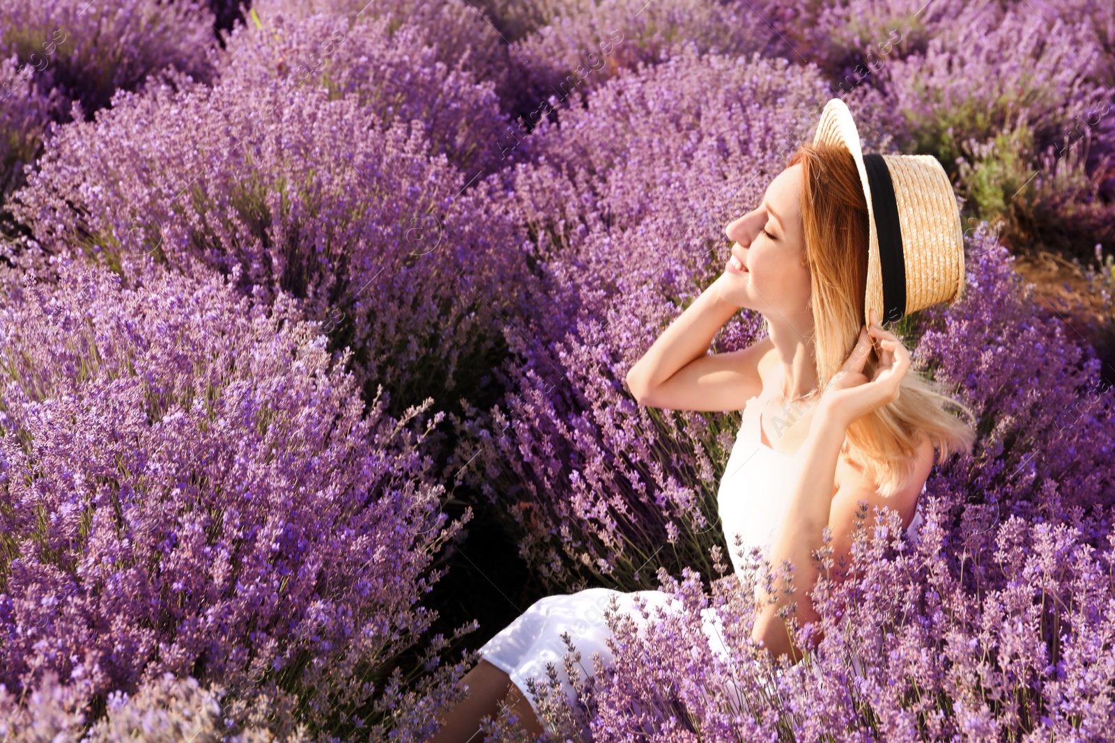 Photo of Young woman in lavender field on summer day