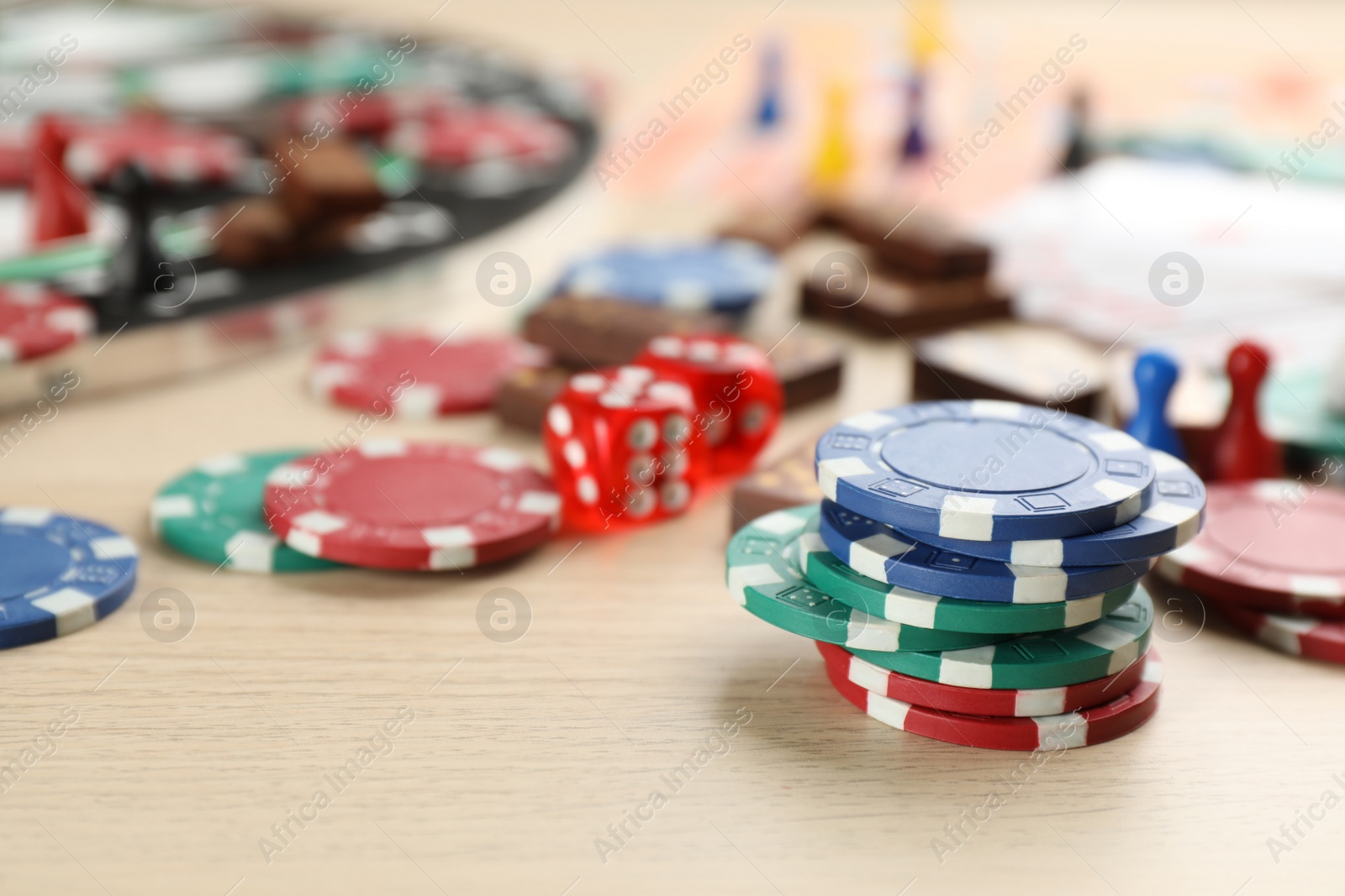 Photo of Elements of different board games on wooden table, closeup