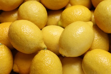 Photo of Fresh lemons as background, closeup. Citrus fruit