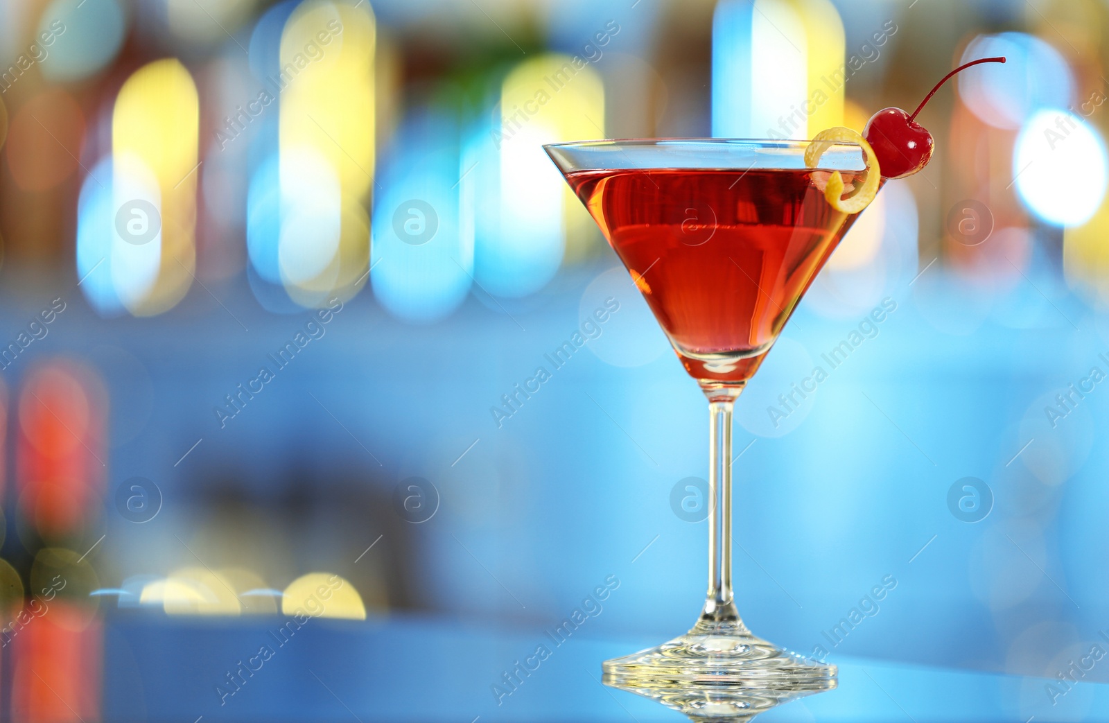 Photo of Glass of fresh alcoholic cocktail on bar counter. Space for text