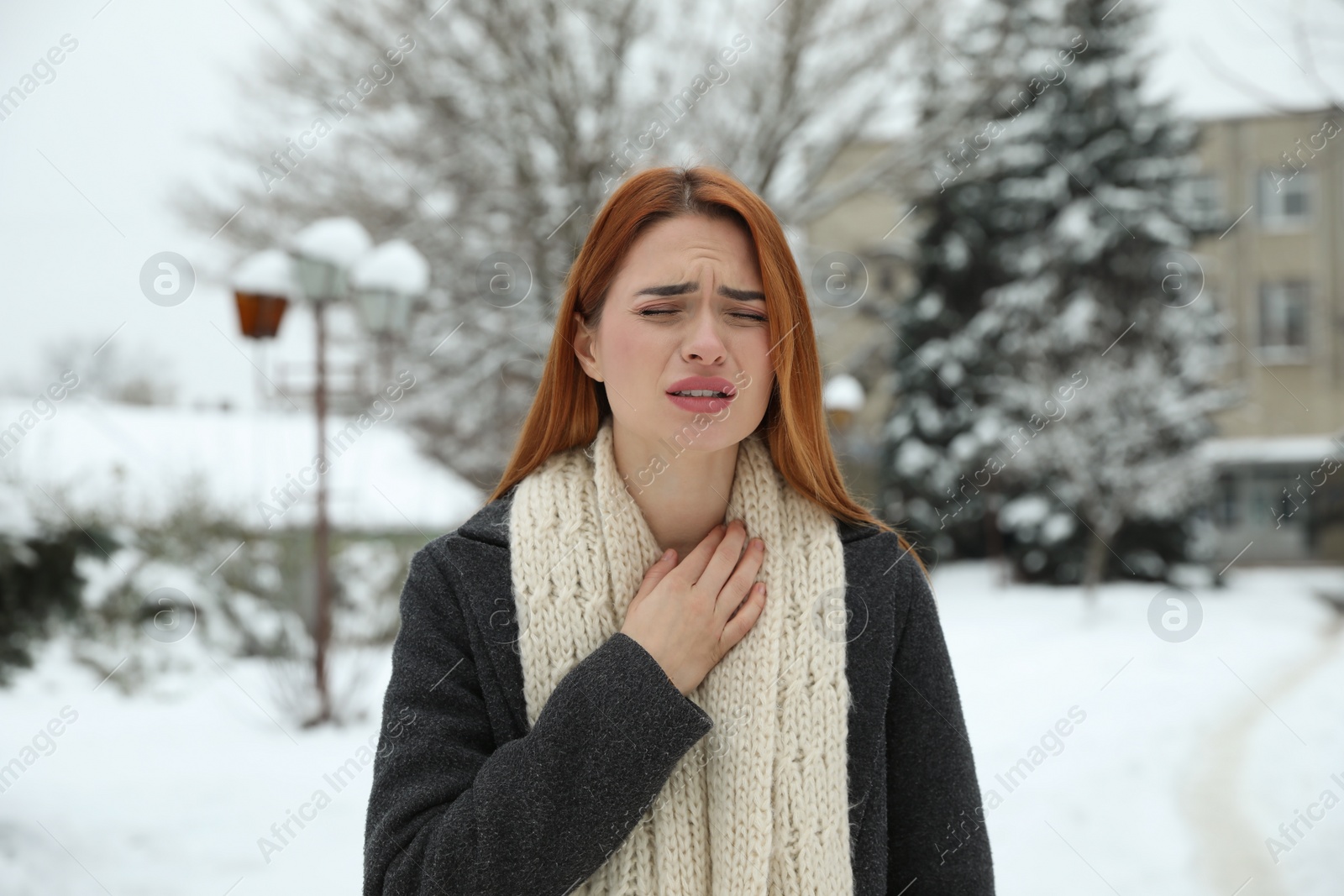 Photo of Beautiful young woman coughing outdoors. Cold symptoms