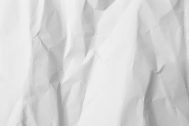 Photo of Sheet of crumpled lilac paper as background, top view