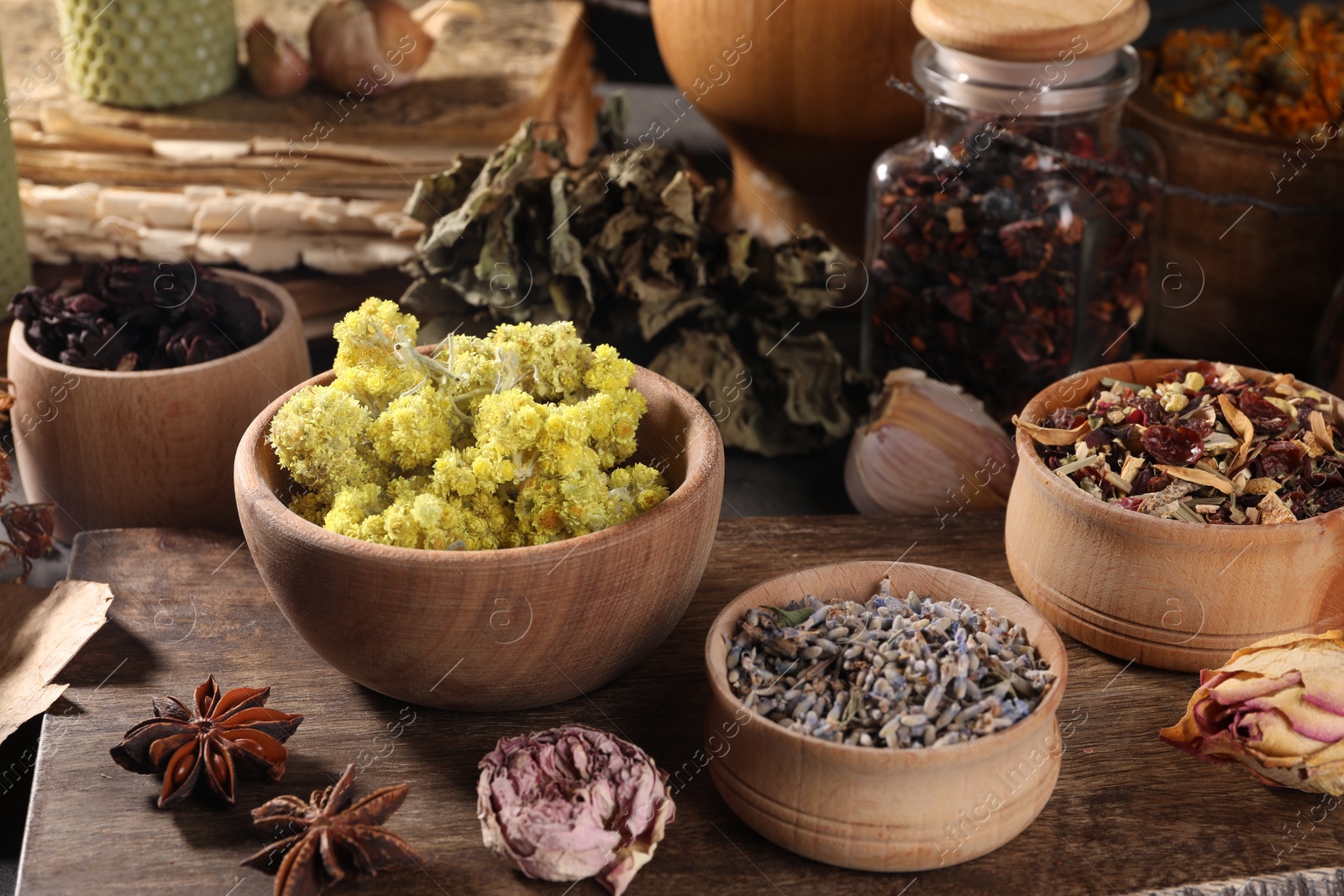 Photo of Many different dry herbs, flowers and anise stars on table