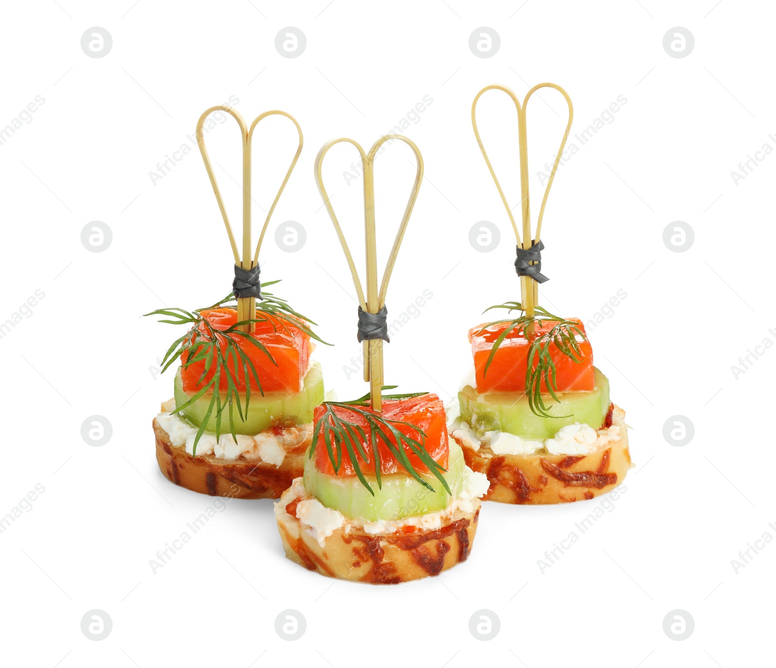Photo of Tasty canapes with salmon, cucumber, bread and cream cheese isolated on white
