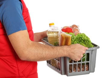 Photo of Man holding basket with fresh products on white background, closeup. Food delivery service