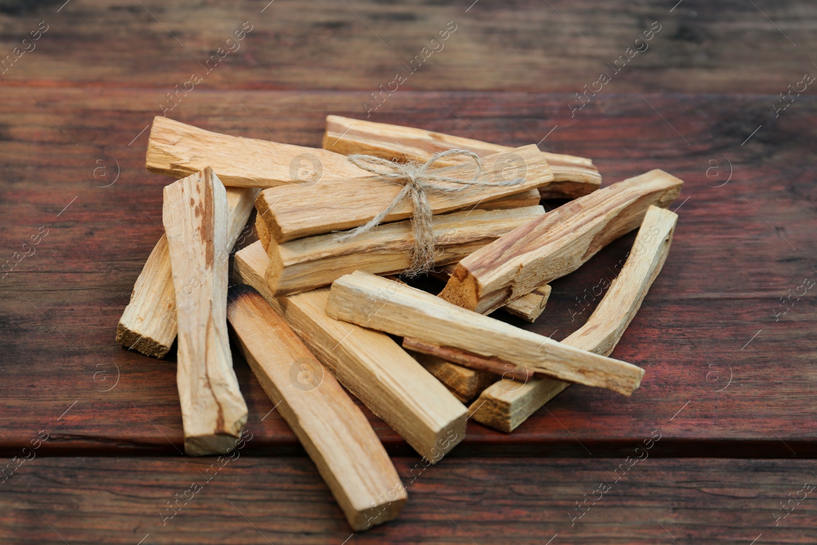 Photo of Many palo santo sticks on wooden table