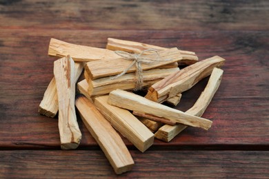 Photo of Many palo santo sticks on wooden table