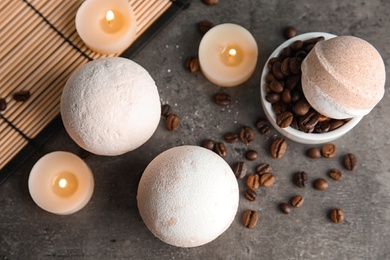 Photo of Bath bombs, coffee beans and candles on table, top view