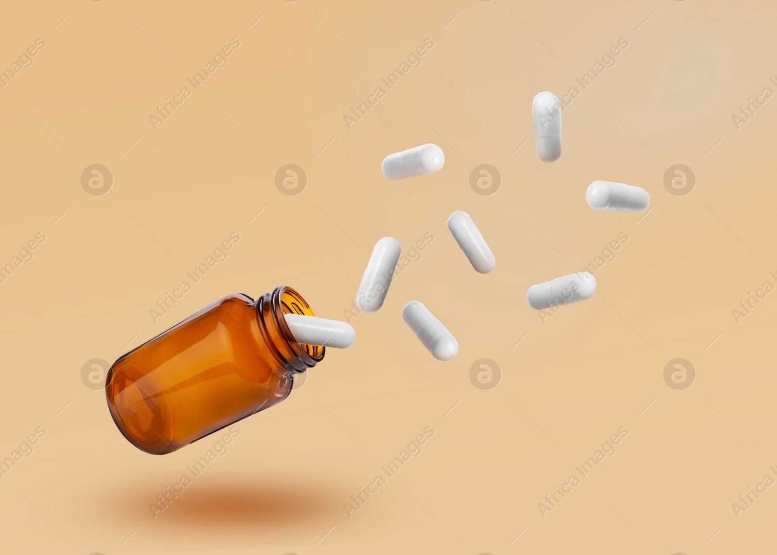 Image of Vitamin capsules flying out from bottle on pale orange background