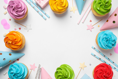 Photo of Flat lay composition with colorful birthday cupcakes on white background. Space for text