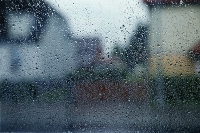 Window glass with water drops, closeup. Rainy weather