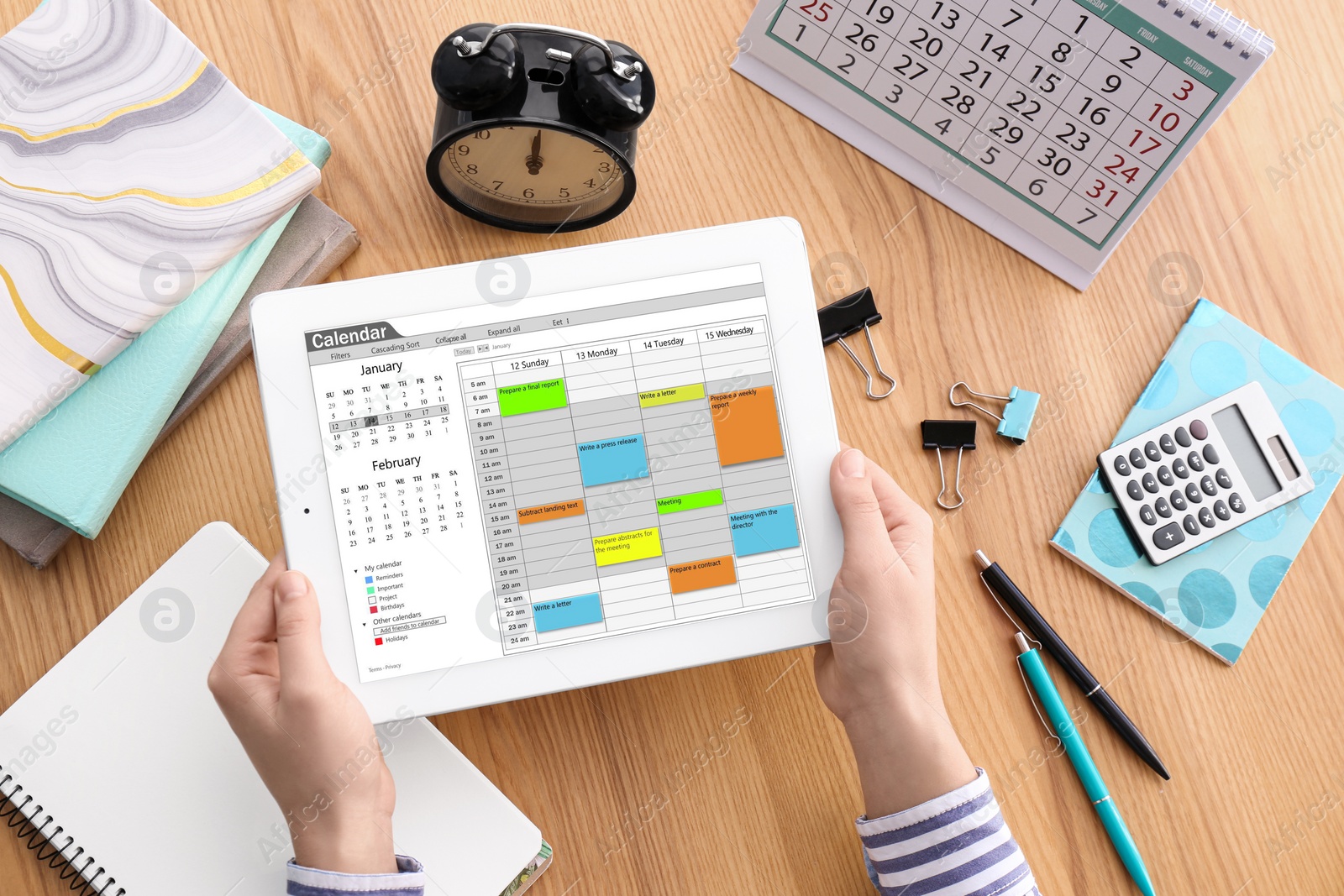 Photo of Woman using calendar app on tablet at table, closeup