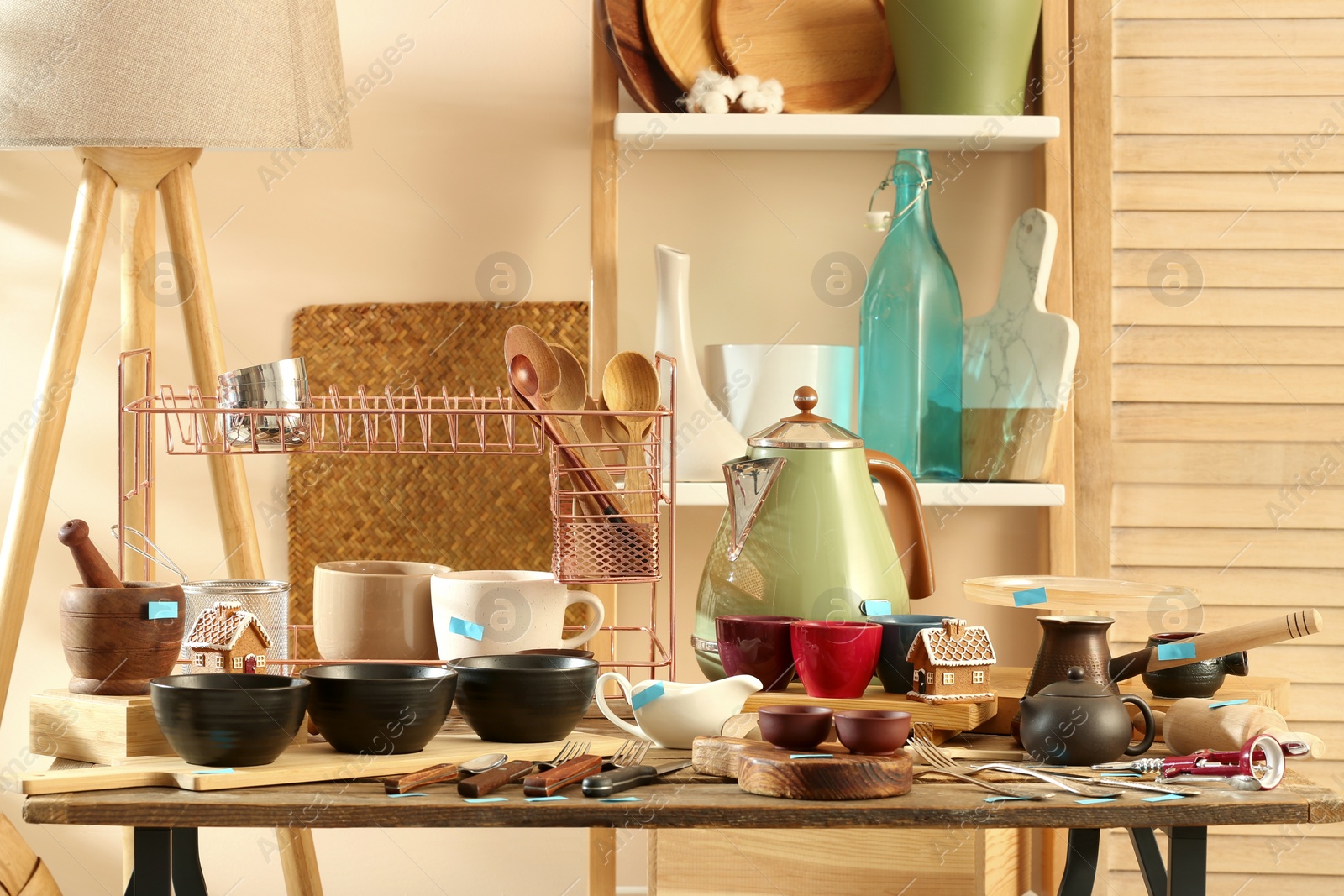 Photo of Many different cooking utensils in room. Garage sale