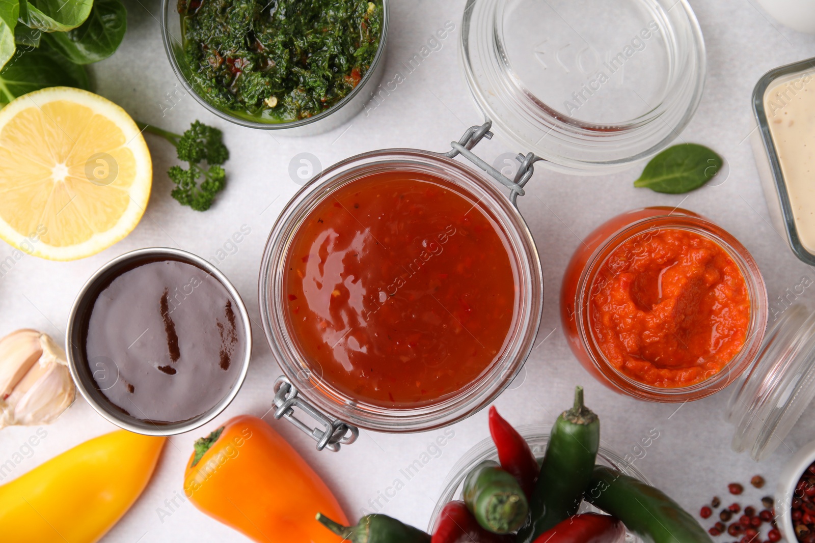 Photo of Different marinades and products on light table, flat lay