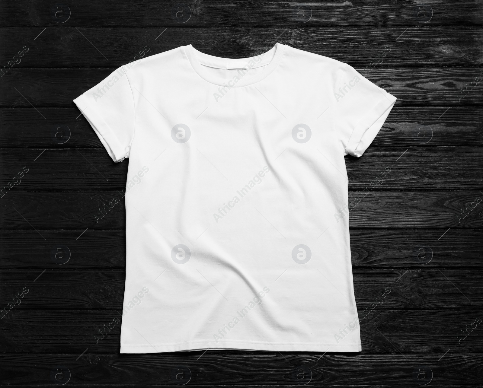 Photo of Stylish white t-shirt on black wooden background, top view