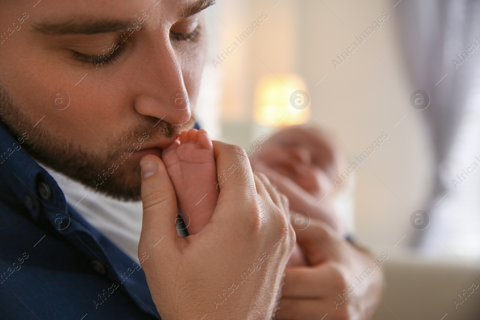 Photo of Father with his newborn son at home, closeup