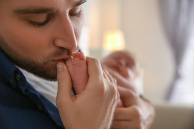 Photo of Father with his newborn son at home, closeup