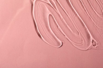 Cosmetic gel on pink background, top view. Space for text