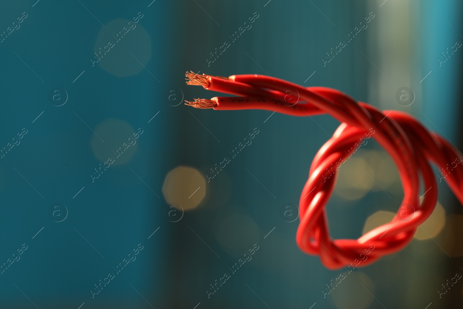 Photo of Stranded copper wires with insulation against blurred background, closeup. Space for text