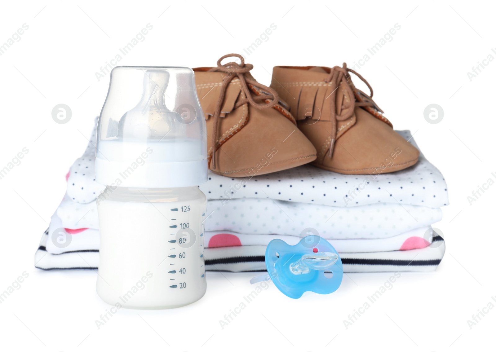 Photo of Set of different baby accessories and feeding mixture in bottle on white background