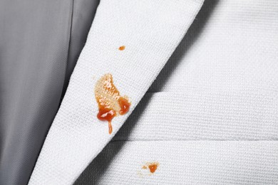 Photo of Dirty jacket with stains of sauce, top view