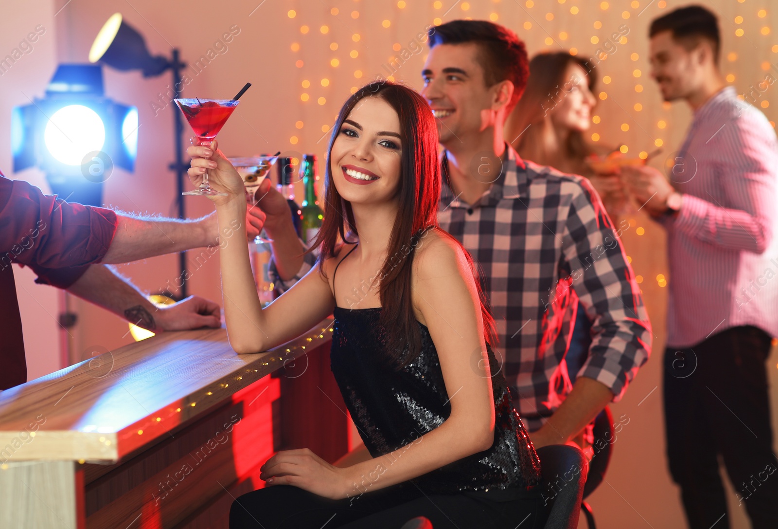 Photo of Young people with martini cocktails in bar