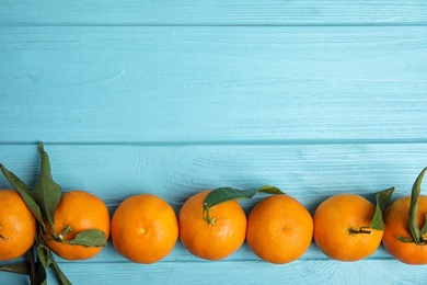 Fresh ripe tangerines and space for text on wooden background, top view