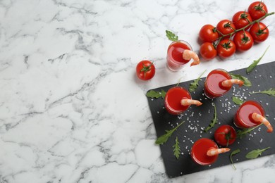 Photo of Shrimp cocktail with tomato sauce served on marble table, flat lay. Space for text