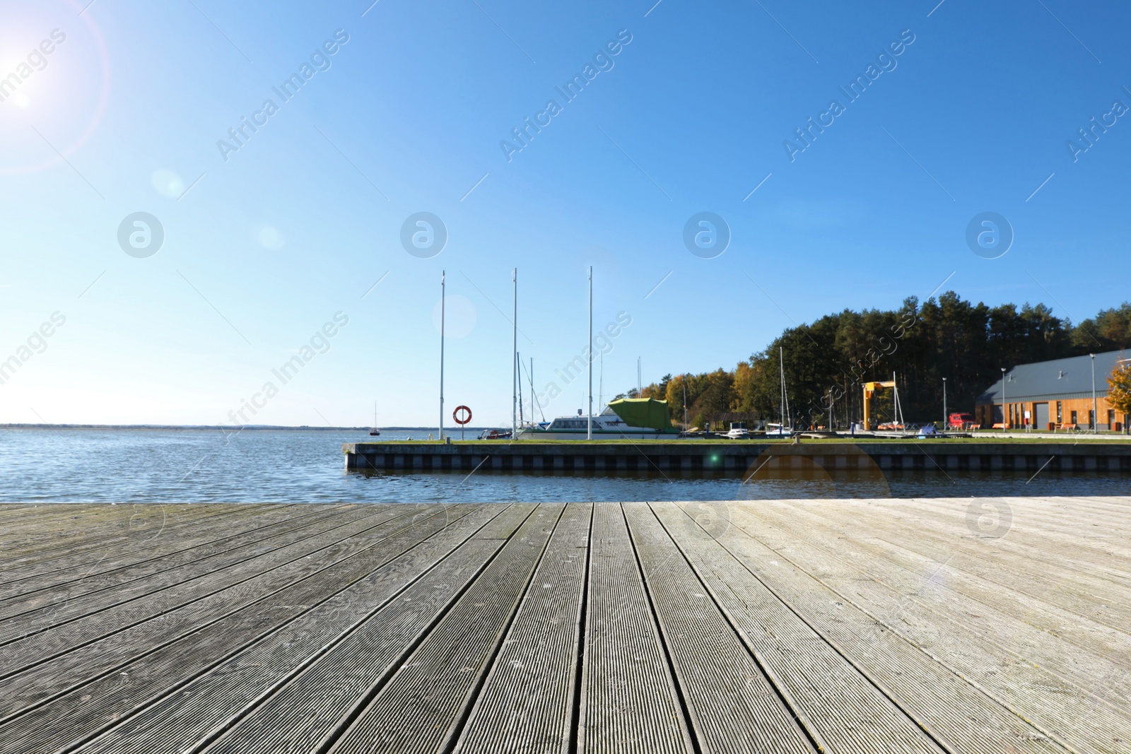 Photo of Beautiful view of wooden terrace near river on sunny day