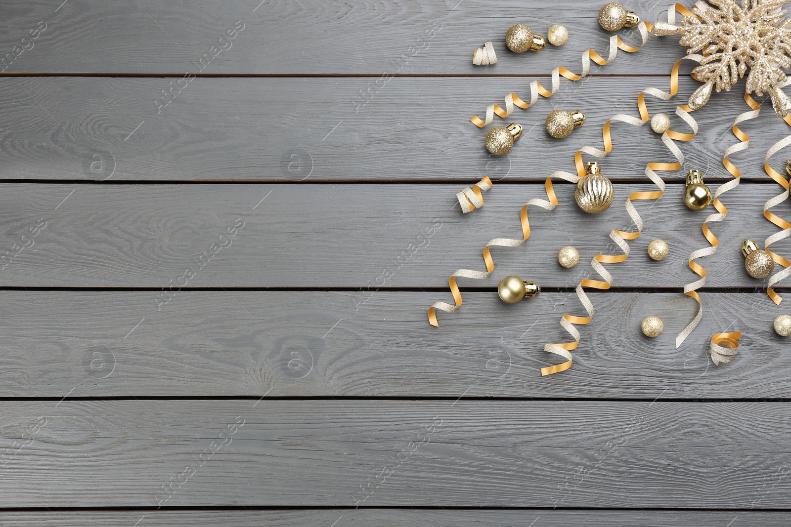 Photo of Flat lay composition with serpentine streamers on grey wooden background, space for text