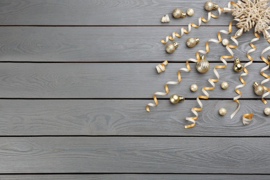 Photo of Flat lay composition with serpentine streamers on grey wooden background, space for text