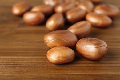 Photo of Raw jackfruit seeds on wooden table, closeup