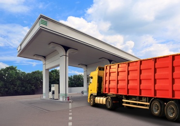Image of Bright truck driving to modern gas filling station