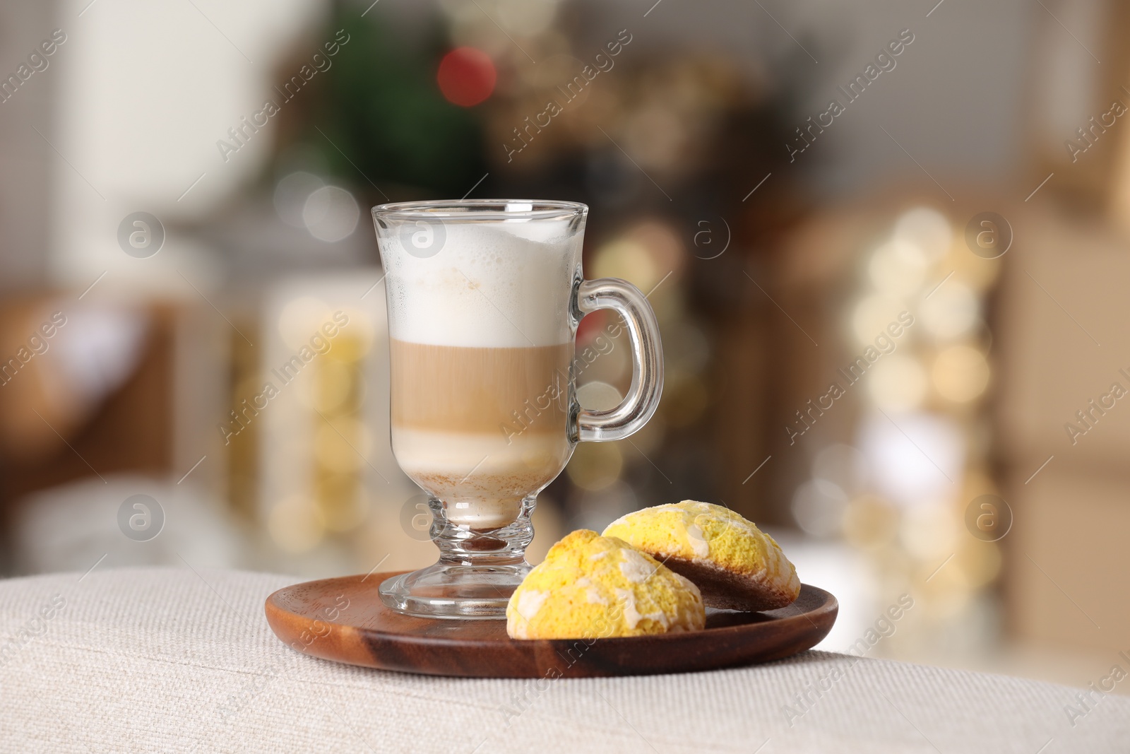 Photo of Aromatic latte macchiato in glass and cookies on white table against blurred background