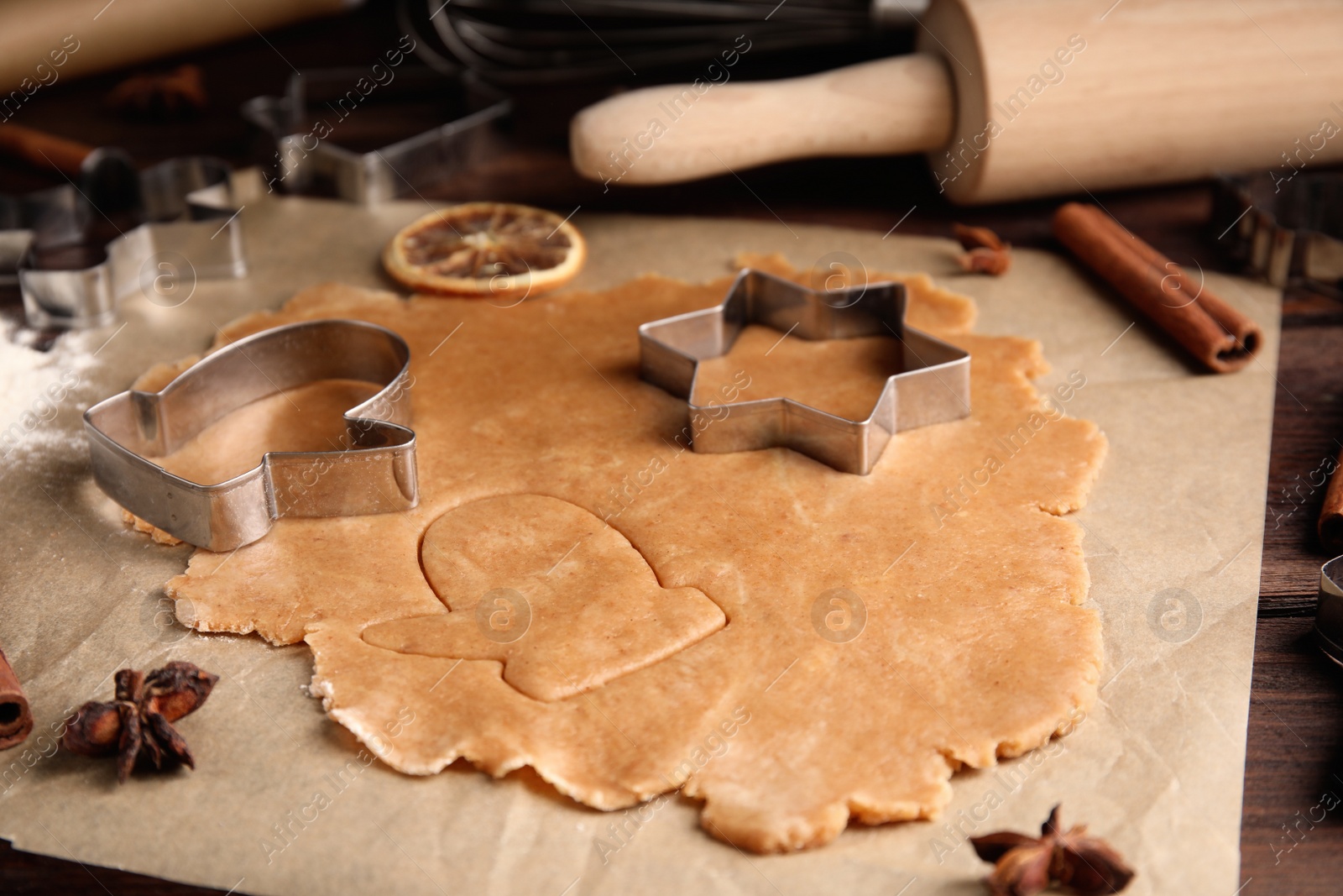 Photo of Making homemade Christmas cookies. Dough and cutters on table, closeup