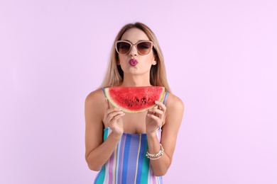 Photo of Pretty young woman with juicy watermelon on color background