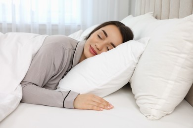 Photo of Beautiful young woman sleeping in bed at home