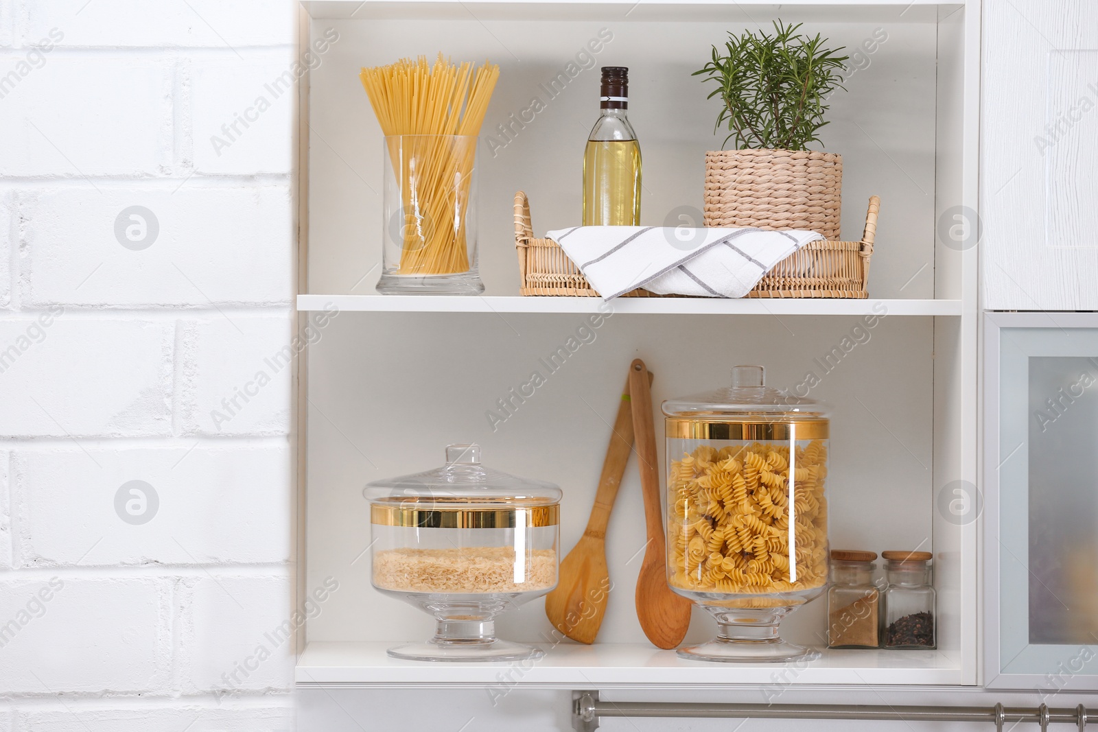 Photo of Shelves with raw foodstuff in modern kitchen