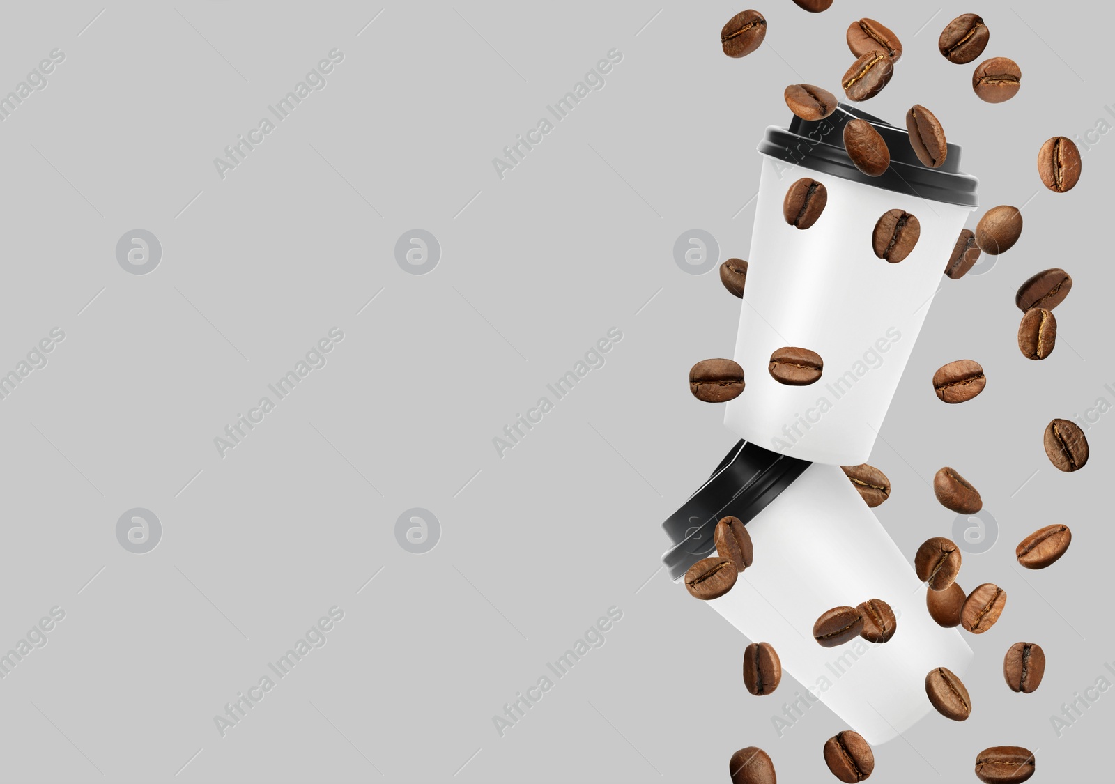 Image of Coffee to go. Paper cups and roasted beans flying on light background, space for text