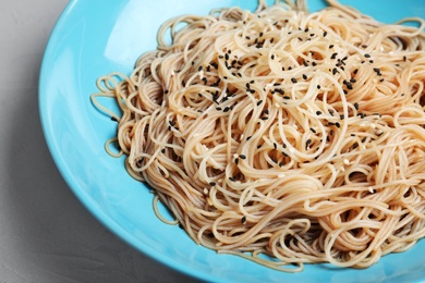 Photo of Plate of noodles with sesame on table, closeup