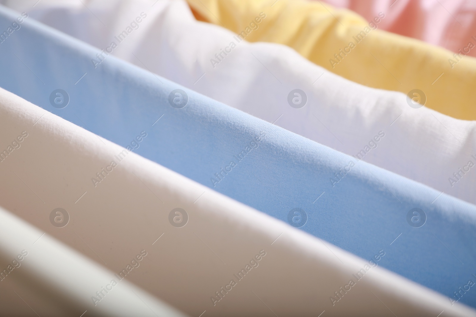 Photo of Clean laundry hanging on drying rack, closeup