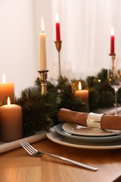 Luxury place setting with beautiful festive decor for Christmas dinner on wooden table