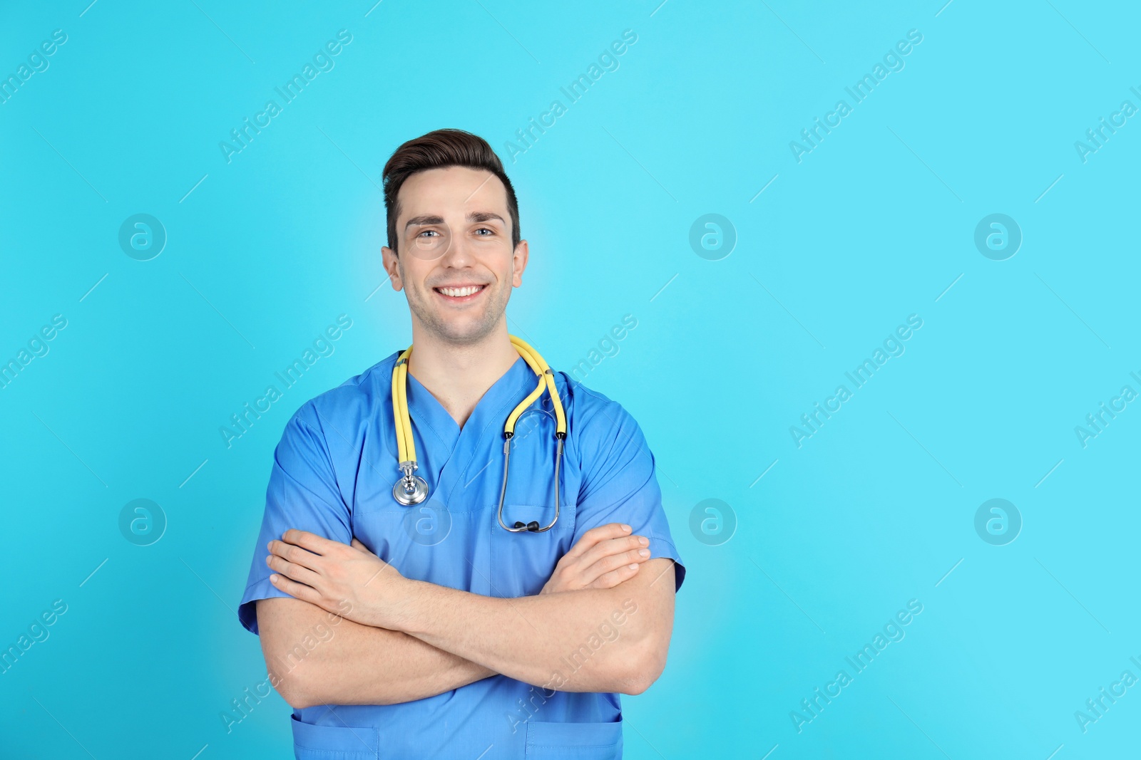 Photo of Portrait of medical assistant with stethoscope on color background. Space for text