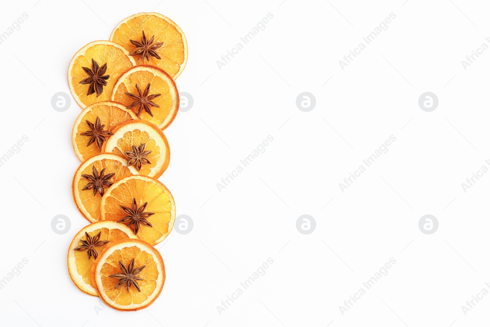 Photo of Flat lay composition with dry orange slices and anise stars on white background. Space for text