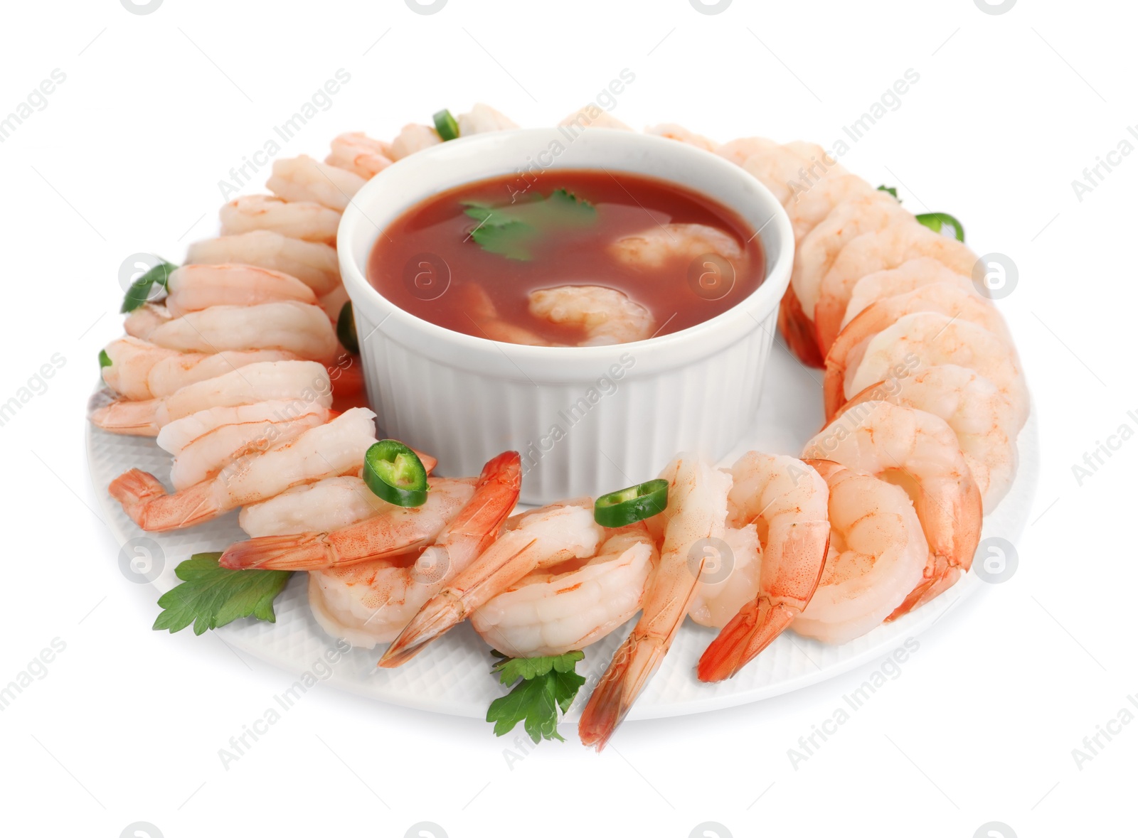 Photo of Tasty boiled shrimps with cocktail sauce, chili and parsley isolated on white